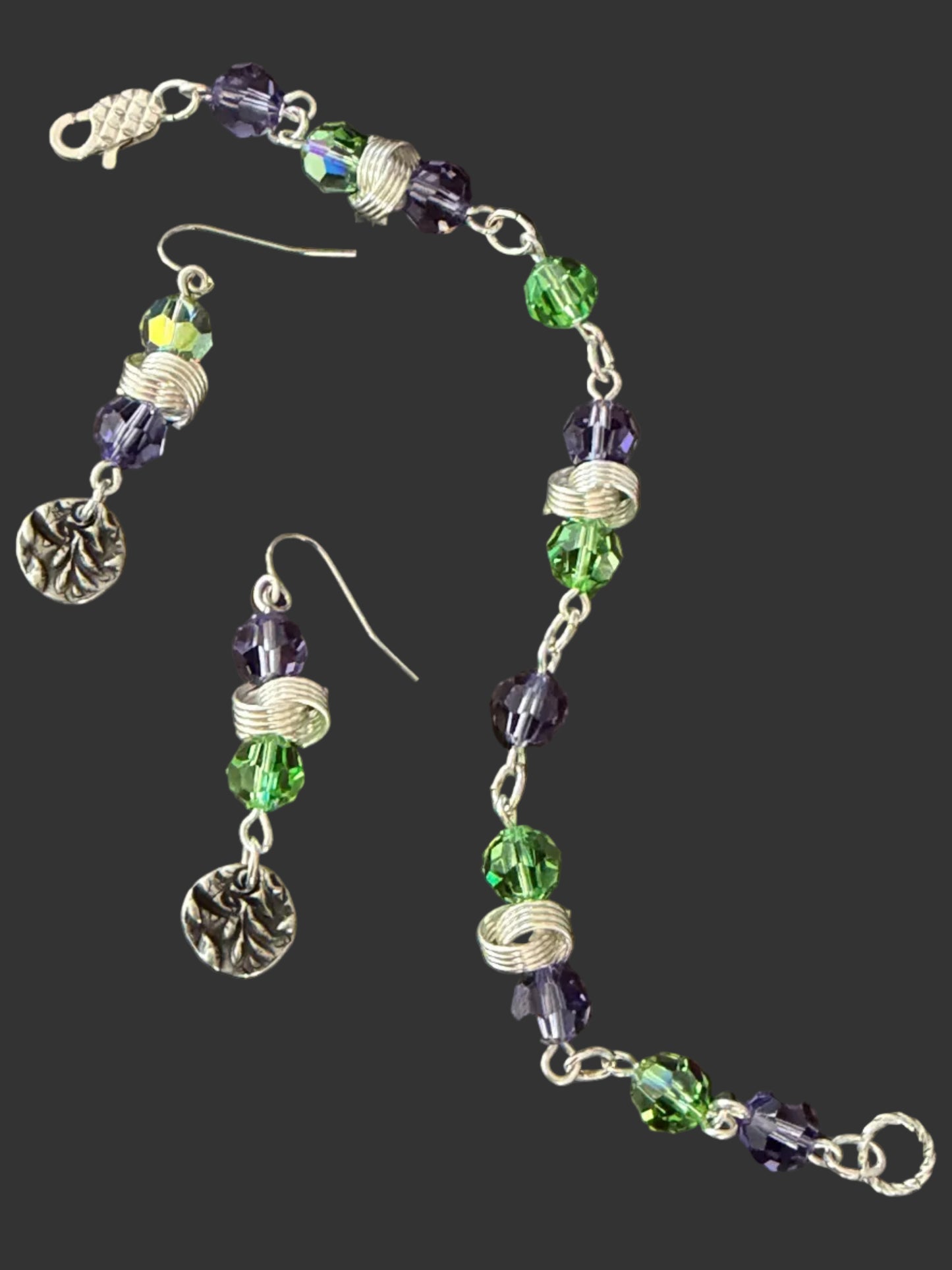 Beaded bracelet and earrings on a dark surface