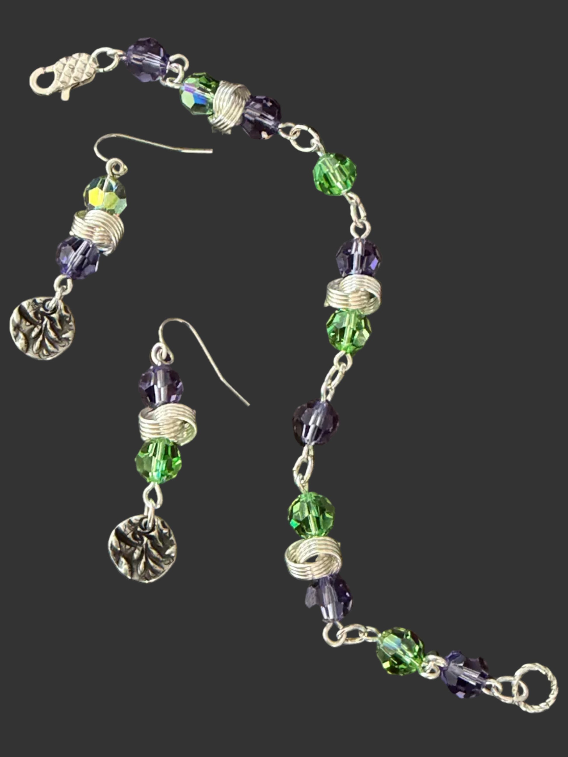 Beaded bracelet and earrings on a dark surface