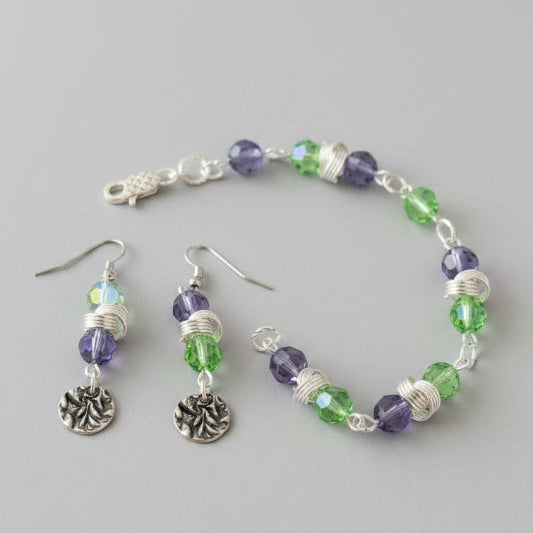 wire and Beaded bracelet and earrings set on a dark surface