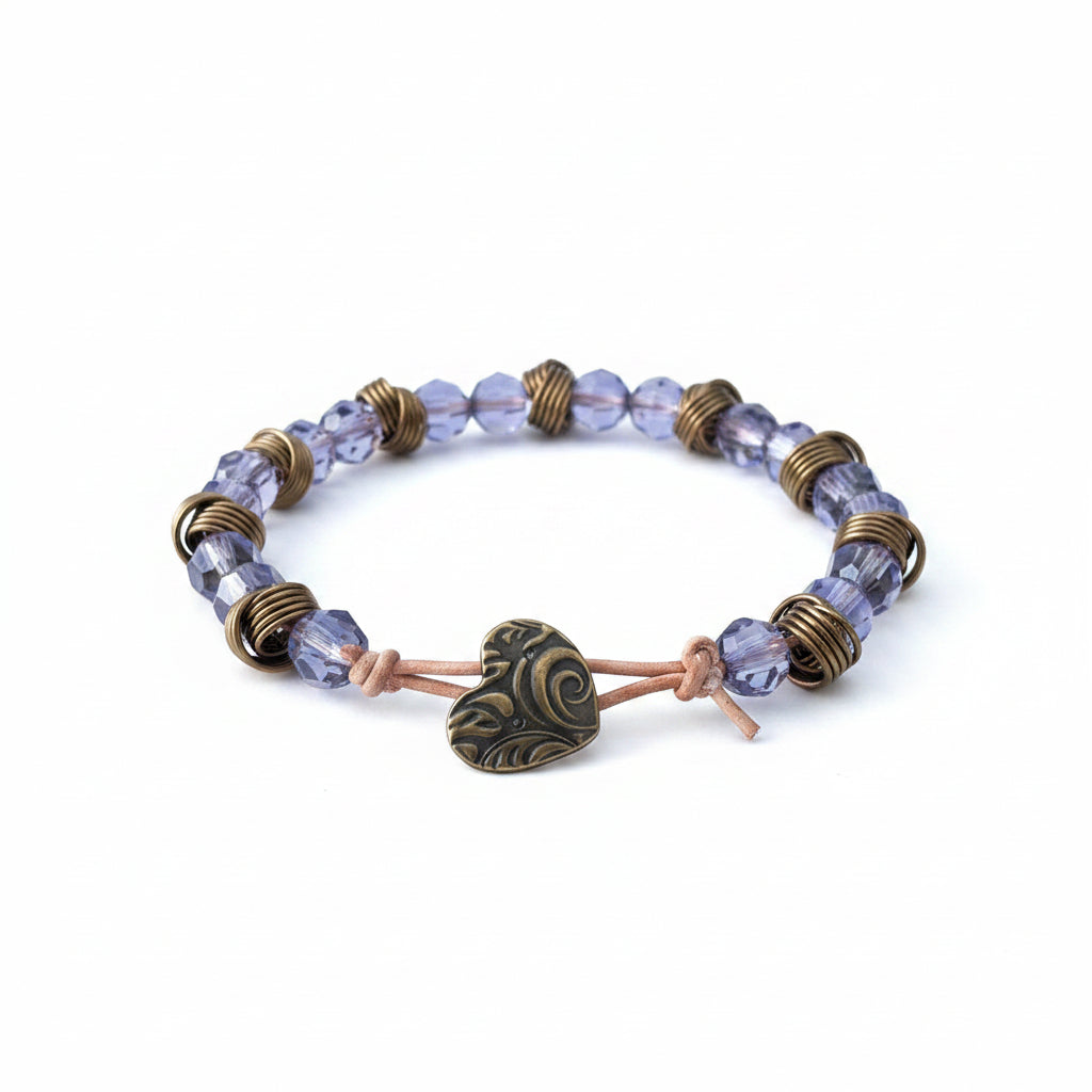Bracelet with blue beads and bronze accents on a light wooden surface
