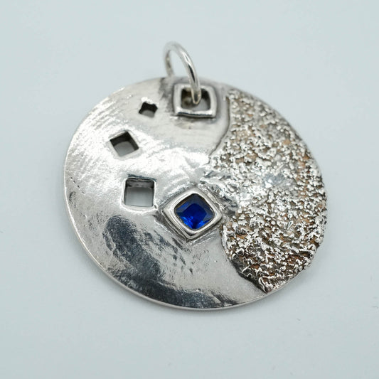 Circular Precious Metal Clay Textured Pendant with Blue Sapphires