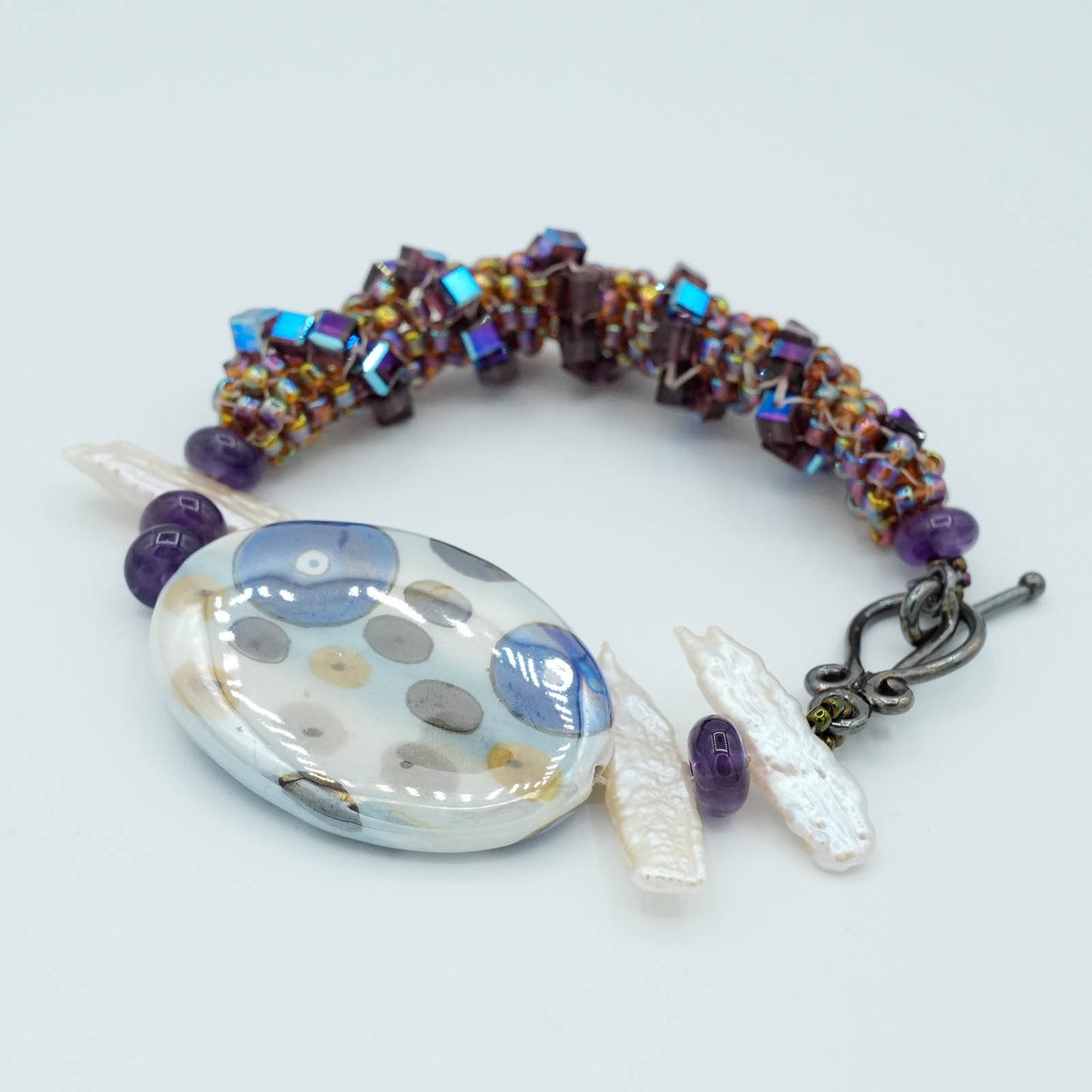 Playful circular Flat Bead with Seed Bead and Crystal Bracelet - Purple tube stitch seed beads