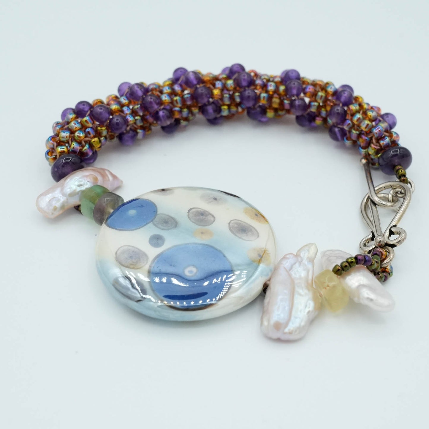 Playful circular Flat Bead with Seed Bead and Crystal Bracelet - Purple tube stitch seed beads